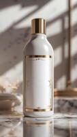 A sleek white bottle with gold accents sits on a marble surface, bathed in gentle sunlight. The clean lines and reflective materials exude elegance. photo