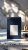 Elegant product box in dark blue with a blank label and gold trim on a luxurious marble surface, light and shadows, sophisticated design. photo