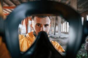 View through the respirator. Man dressed ,in chemical protection suit in the ruins of the post apocalyptic building photo