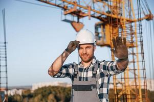 Stop gesture by the hand. Man, is working on the construction site at daytime photo