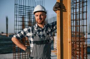 Confident worker. Man is on the construction ,site at daytime photo