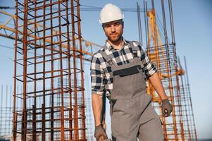 Front ,view ,of man that is working on the construction site at daytime photo