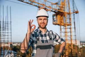 Front view of man that is working on the construction site at daytime photo