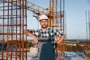 Front view of man that is working on the construction site at .daytime photo