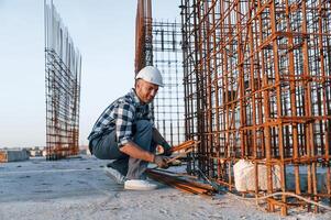 With ,rusty metal objects. Man ,is working on the construction site at daytime photo