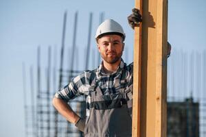 Standing and posing. Man is working ,on the ,construction site at daytime photo