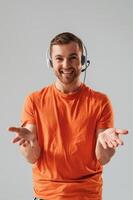Conception of ,call center. In headset. Handsome man is in the studio against white background photo