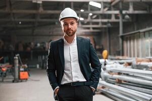 Front view. Manager in ,black, formal wear at the factory photo