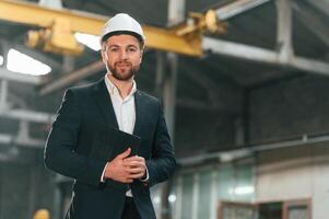 Portrait of manager that is in ,black formal wear at the factory photo