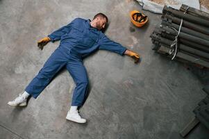 Top view of dead factory ,worker that lying on the ground. Conception of safety, bad accident photo