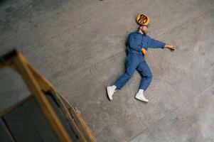 Top view of, dead factory worker that, lying on the ground photo