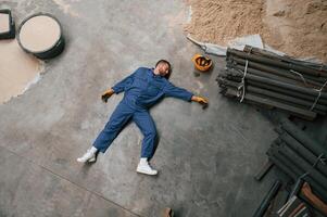 Top view of dead factory worker that lying on ,the ground. Conception of safety, bad accident photo