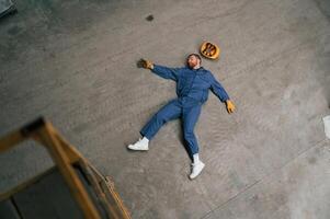 Top view, of dead factory worker that lying on the ground photo