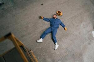 Top view of dead factory worker that lying on ,the ,ground photo
