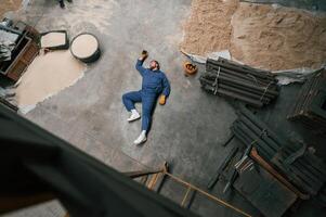 Top view of ,dead factory worker that lying on the ground. Conception of safety, bad accident photo