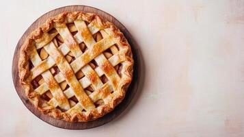 Golden Brown Apple Pie with Lattice Crust on Wooden Board photo
