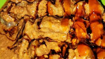 a plate of food with sauce and meat photo