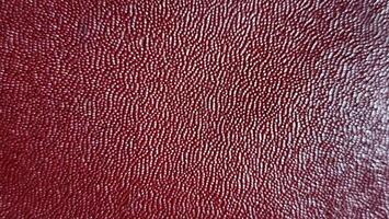 a close up of a red leather surface photo