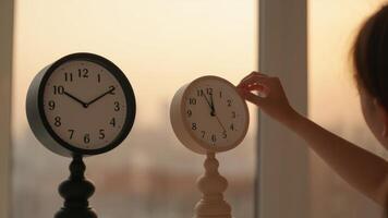 Concept of time management with clocks being adjusted for daylight saving time photo