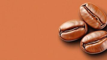 Three glossy, roasted coffee beans arranged on warm, textured brown surface, with copy space photo