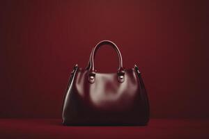 Maroon Leather Handbag on a Red Background photo