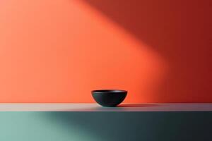 Black Bowl on Teal and Orange Platform with Sunlight photo
