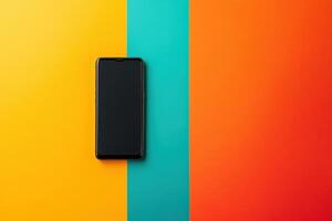 Black Smartphone on Yellow, Teal, and Orange Background photo