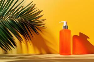 Orange Bottle of Lotion with Palm Leaf Shadow on Yellow Background photo