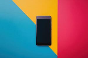 Black Smartphone on a Tricolor Background of Blue, Yellow, and Red photo