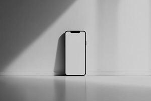 A Black Smartphone on a White Surface with Shadows photo