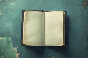 Open Vintage Book on Weathered Teal Surface photo