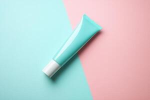 Blue Tube of Lotion on Blue and Pink Background photo