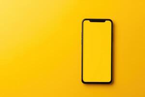 Black Smartphone with Blank Screen on Yellow Background photo