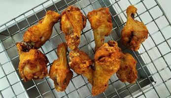 Crispy Fried Chicken Drumsticks on Cooling Rack Display photo