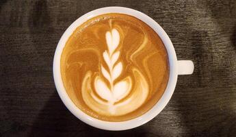 Beautiful Heart and Leaf Latte Art in a White Coffee Cup photo