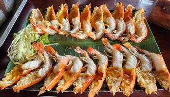 Grilled Shrimp Dish Served on Green Banana Leaf in Tropical Setting photo