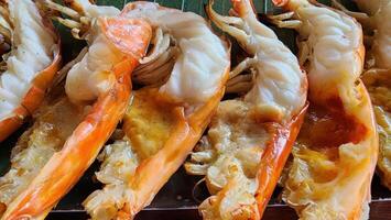 Grilled Shrimp on Green Banana Leaf with Charred Texture and Detail photo