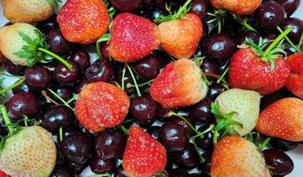 Fresh Strawberries and Cherries on a White Background photo