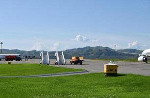 Ladder ladder at the rear entrance of a passenger aircraft, view of the tail and apron of the airport photo