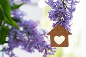 keys and keychain in the form of a house , a symbol of the family hearth and own home. Purchase of real estate. photo