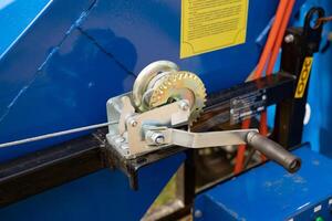 Manual cable winch with hook isolated in white back on a sunny day photo