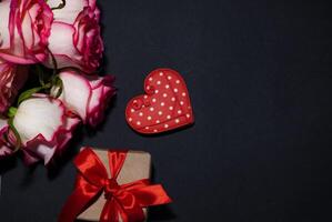 Vertical Valentines Day background with blank paper card mockup, red hearts, confetti on pink. photo