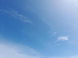 White clouds in the blue sky. Light cloudy, good weather. Curly clouds on a sunny day. photo