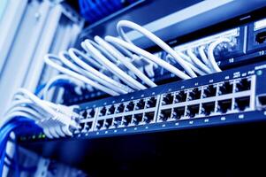 Network switch and ethernet cables in red and white colors. Data Center photo