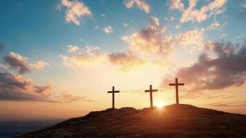 Three Crosses Silhouetted Against a Golden Sunset Sky photo