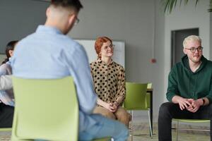 A diverse multiethnic business team engages in a collaborative meeting, discussing strategies and solutions in a modern office setting photo