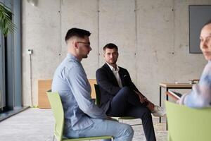 A diverse multiethnic business team engages in a collaborative meeting, discussing strategies and solutions in a modern office setting photo