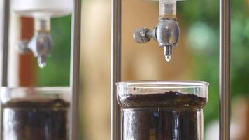 Brewing coffee using a siphon technique at a cafe video
