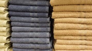 Stacked towels in a store display with various textures and colors video