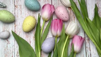 Easter eggs and tulips on rustic wooden table video
